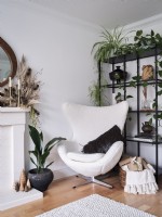 Modern white armchair in corner of living room