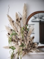 Detail of dried flower arrangement on mantelpiece