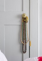 Detail of bead necklaces on door handle