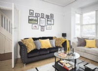 Modern living room with black sofa and yellow cushions