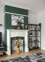 Green painted chimney breast around fireplace in modern living room