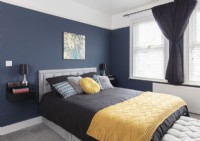 Dark blue, black and yellow modern bedroom