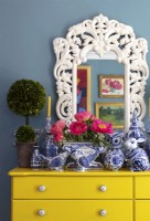 Display of blue and white ceramic ornaments on yellow drawers
