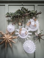 Paper Christmas decorations and advent calendar on wood panel