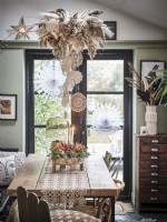 Dining table with hanging feather and doily decorations