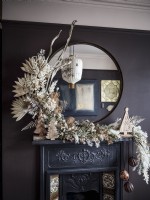 Ornate fireplace with dried flower garland