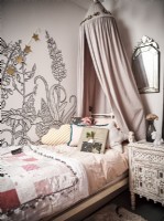 Children's bedroom with bedstead and canopy and feature wall