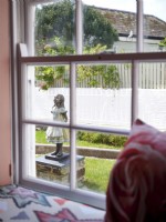 Alice in Wonderland statue through window