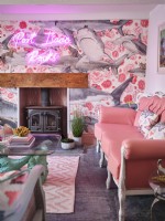 Coastal themed living room with pink furniture and fireplace