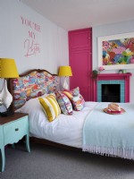 Pink  and  white bedroom with upholstered bed