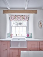 Kitchen window with butler basin, pink units and blind