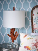 Brown and white coral sculptured lamp next to upholstered bed