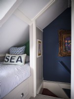 Blue and white coastal themed interior in attic bedroom