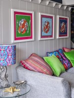 Matching colourful wall artwork and cushions and sea horse lampshade