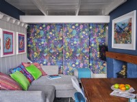 Colourful dining room with feature wall, panelled wall and marine artwork