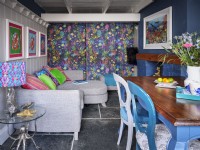 Colourful open plan dining room with coastal inspired ornaments, furnishings and artwork