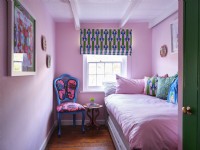 Pink bedroom with upholstered chair 