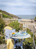 Picturesque coastal terrace with light blue furniture