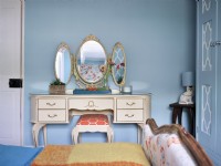 Vintage dressing table vanity with gold mirrors and upholstered stool