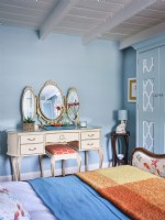 Gold vintage dressing table vanity in blue coastal themed room