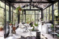 Open plan living and kitchen in greenhouse