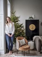 Homeowner in Christmas setting with Christmas tree and chair