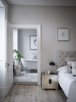 View from bedroom to classic en suite bathroom with house plants