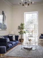 Blue sofa in open living room with feature window