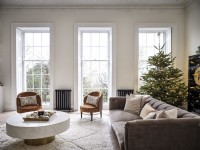 Living room with a muted tones theme and three large windows