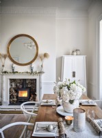 Neutral dining room featuring Christmas decor and wood burning stove