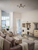 Cream open plan living room featuring seating and soft furnishings