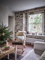Country living room with exposed stonework and Christmas decorations 