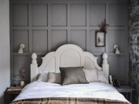 Rustic bedroom featuring symmetrical bedside tables and cushions