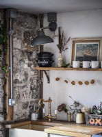 Retro kitchen featuring exposed pipes and stonework