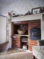 Chimney breast featuring Christmas decor and jute rug
