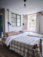Country twin bed bedroom with exposed brickwork