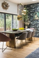 Vintage picture on patterned feature wall in modern dining room