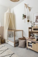 Nursery with canopy over cot bed and play kitchen