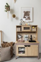 Wooden play kitchen unit in childrens room