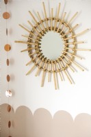 Bamboo cane sunburst mirror on childrens bedroom wall - detail