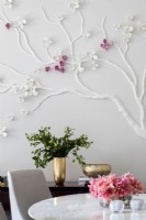 Dining room wall decorated with dogwood tree with white and pink flowers.