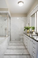 Modern white marble bathroom with double sinks.