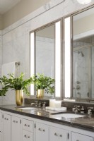Modern white marble bathroom with double sinks,