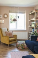 Mustard coloured retro armchair in modern living room