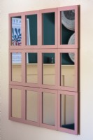 Display of pink framed mirrors on wall
