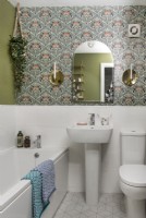 Patterned retro wallpaper in modern white bathroom