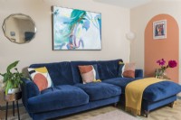 Large dark blue sofa in living room with painted walls