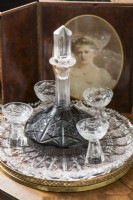 Decanter and glasses next to old portrait painting - detail