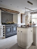 Modern kitchen with island unit, exposed brickwork and Christmas decor