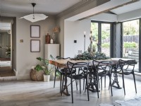 Neutral open plan room featuring dining table and chairs